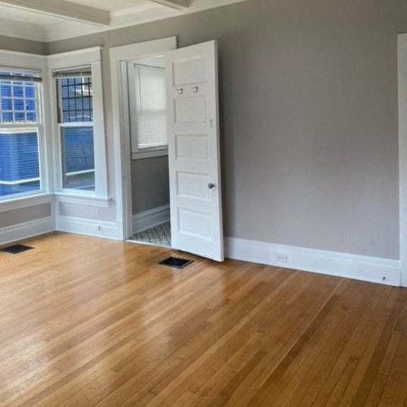 a room with a ceiling fan and a wooden floor.