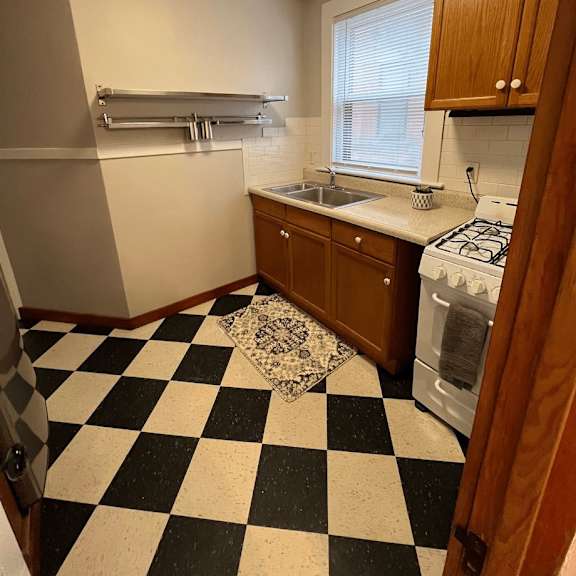 a black and white checkered floor in a kitchen.