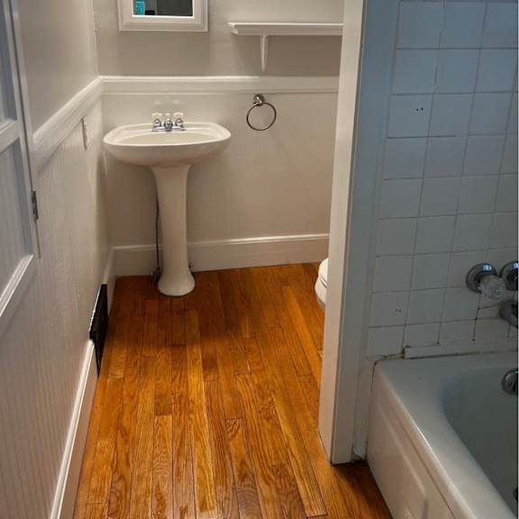 a small white sink in a small bathroom.
