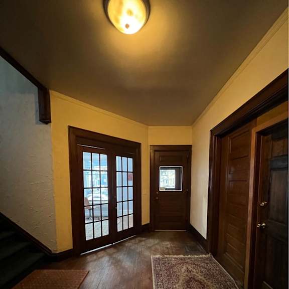 a hallway with a rug on the floor and a light on the ceiling.