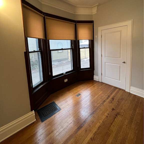 a room with a white door and a window with blinds.
