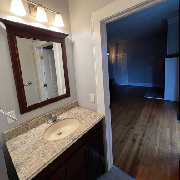 a bathroom with a sink and mirror.