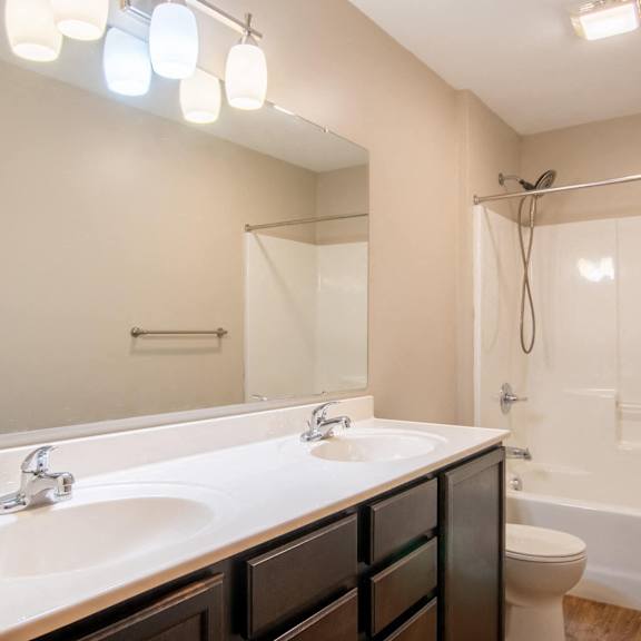 a bathroom with a white sink and a white tub.