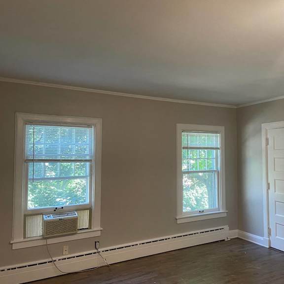 a room with two windows and a door.