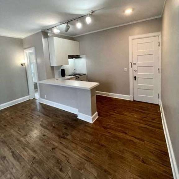 a room with a wooden floor and a white door.
