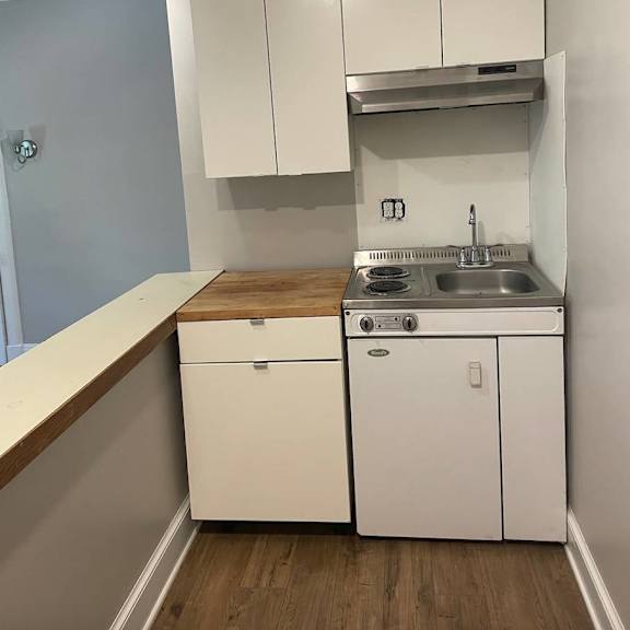 a small kitchen with a white dishwasher and a white sink.