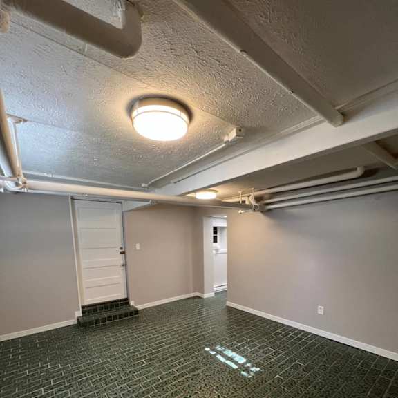 a room with a green tiled floor and white walls.
