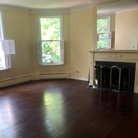 a room with a fireplace and a large window.