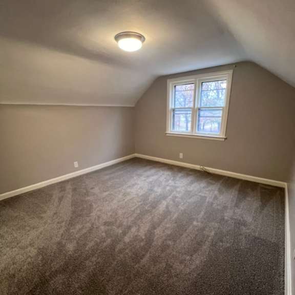 a room with a carpeted floor and a window.