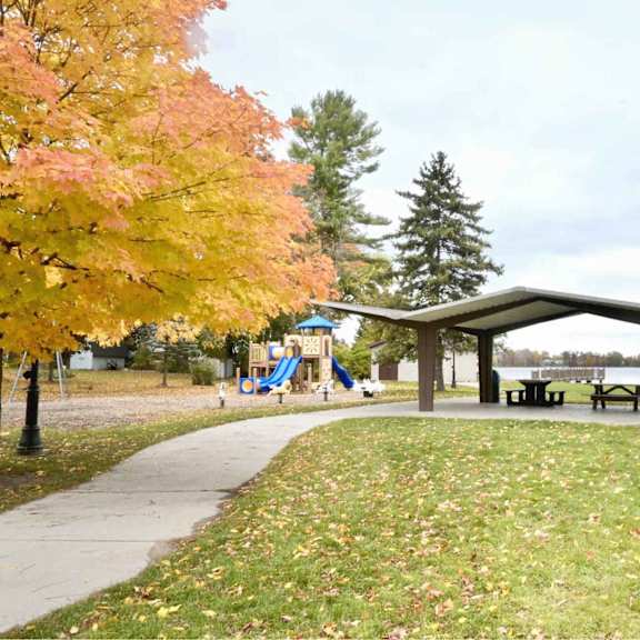 a park with a pavilion, benches, and a playground.