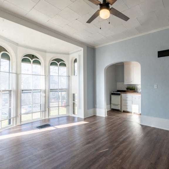 a room with a ceiling fan and a cabinet.