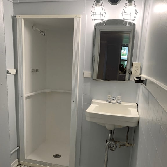 a white toilet is next to a sink in a small bathroom.