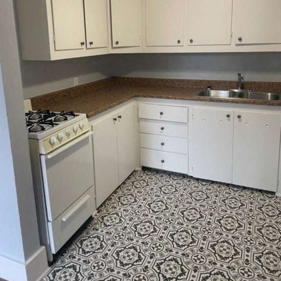 a kitchen with a black and white floor.