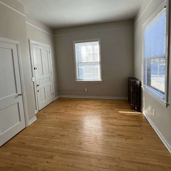 a room with wooden floors and white walls.