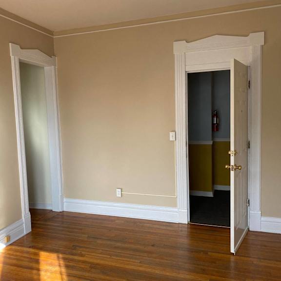 a room with a white door and a window.
