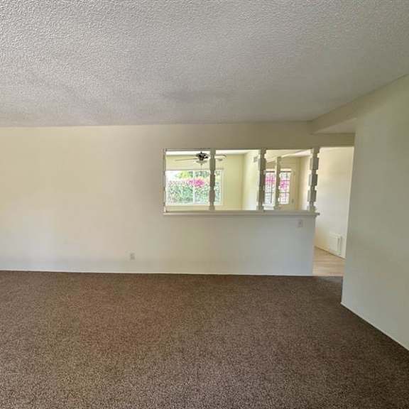 a room with a carpeted floor and a window.