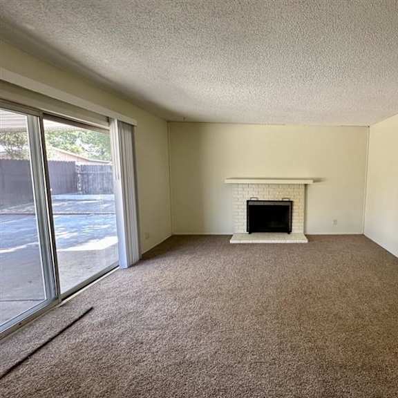 a room with a fireplace and carpeted floor.