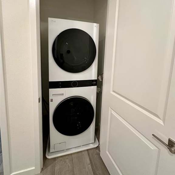 two washing machines in a small laundry room.