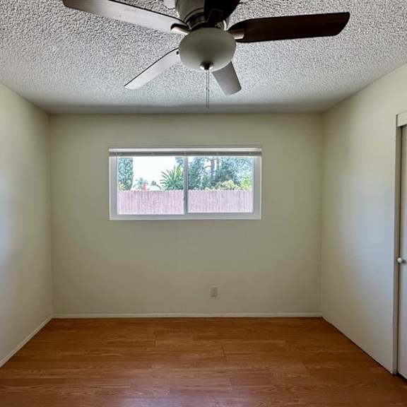 a room with a ceiling fan and a window.