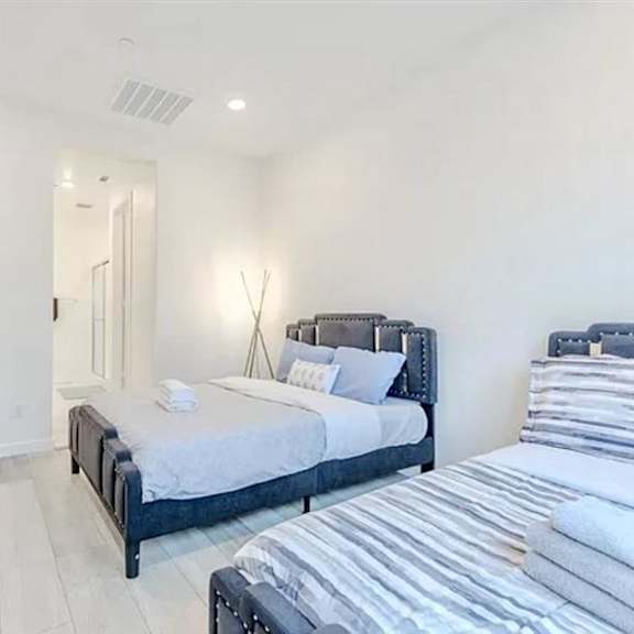 a bedroom with a large bed and a mirror on the wall.