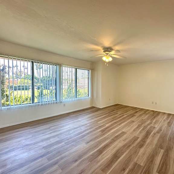 a room with wooden flooring and a ceiling fan.