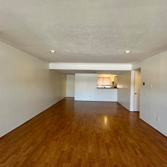 a room with wooden floors and white walls.