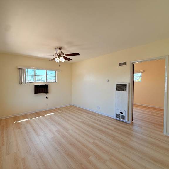 a room with a ceiling fan and a window.