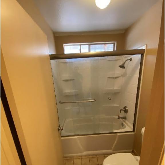 a small bathroom with a toilet and a walk in shower.