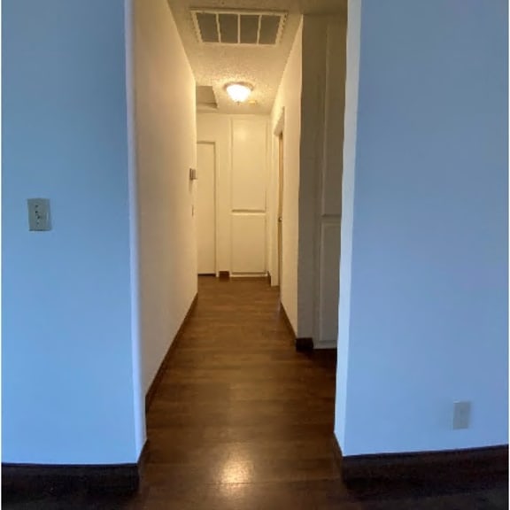 a hallway with a door at the end.