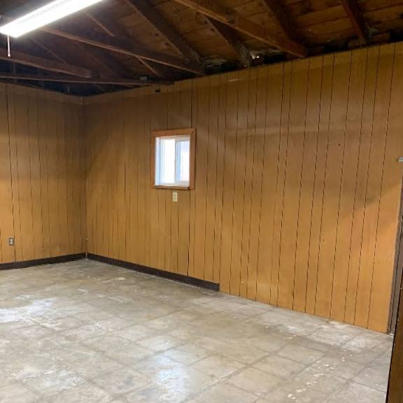 a room with wooden walls and a window.