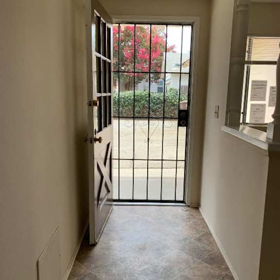 a hallway with a gate leading to a balcony.
