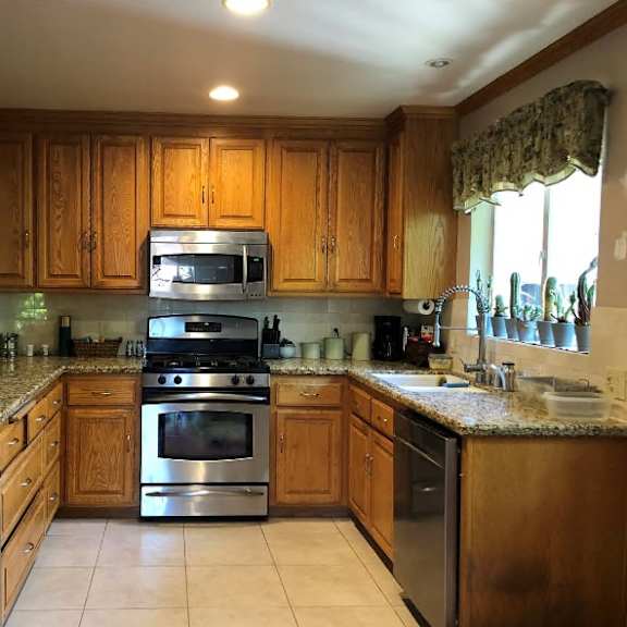 a kitchen with wooden cabinets and granite countertops.