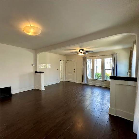 a room with wooden floors and white walls.