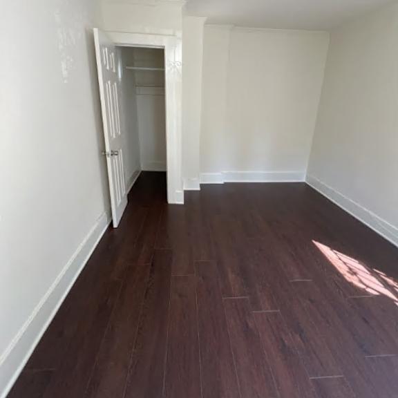 a room with a white wall and a doorway leading to another room.