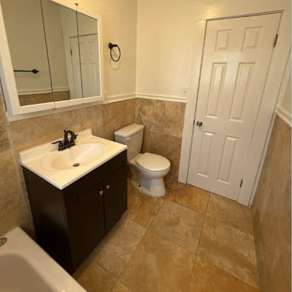 a bathroom with a sink, toilet and tub.