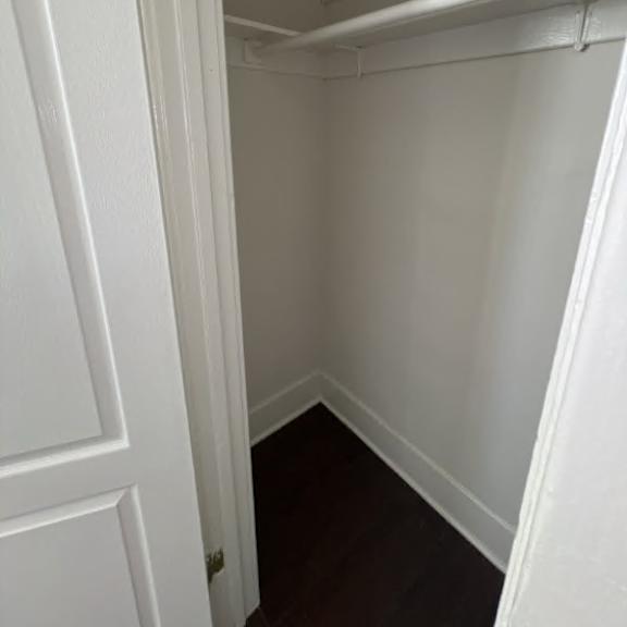 a white door with a gold lock is open.