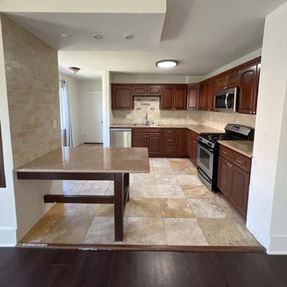 a kitchen with a table and chairs in the middle of the room.