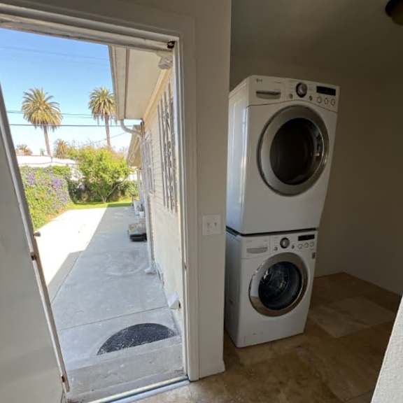 a white washing machine and dryer in a laundry room.