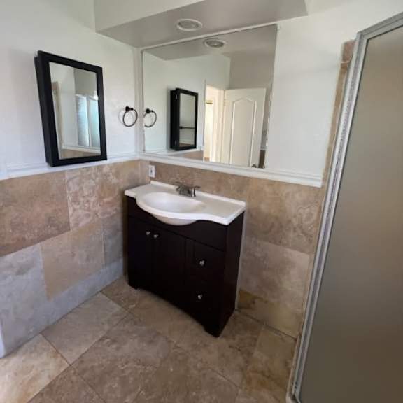 a bathroom with a sink and mirrors.
