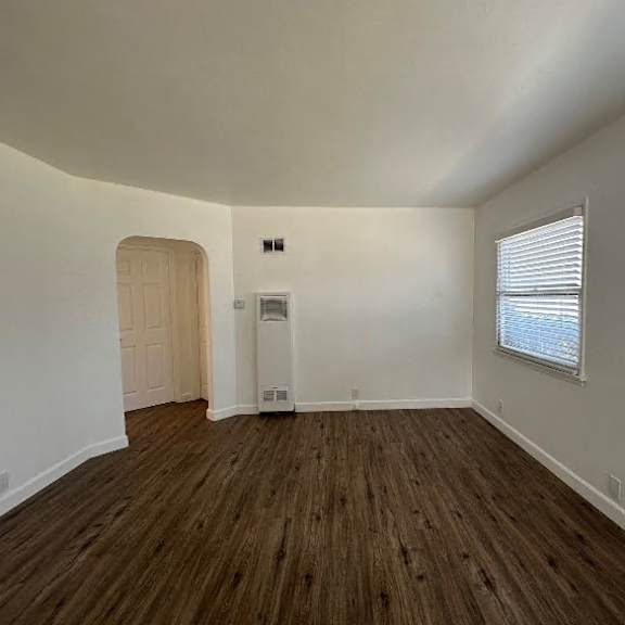 a room with wooden floors and white walls.