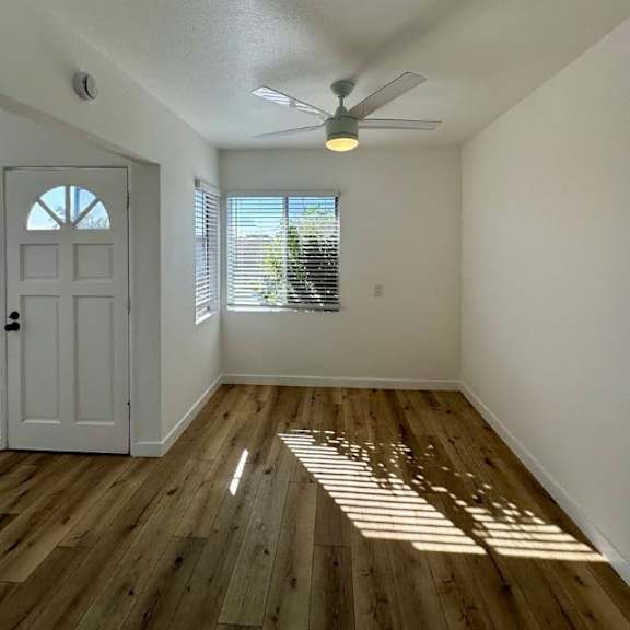 a room with a white door and a window with blinds.