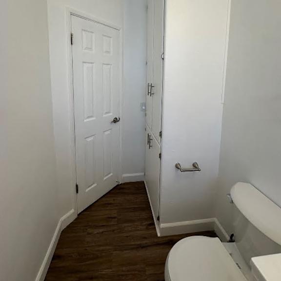 a white door is on the left and a white cabinet is on the right.