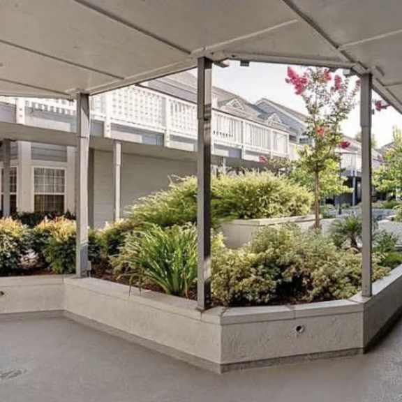 a long walkway with a planter on the side.
