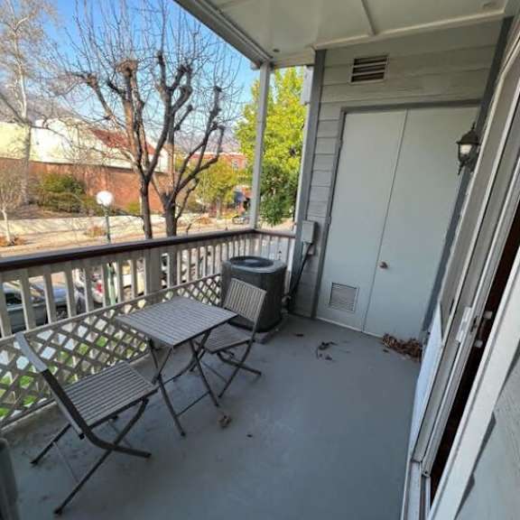 a patio with a table and chairs is shown.