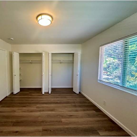 a room with a wooden floor and white walls.