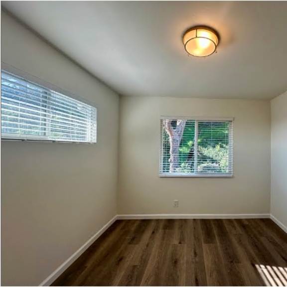 a room with a window and a wooden floor.