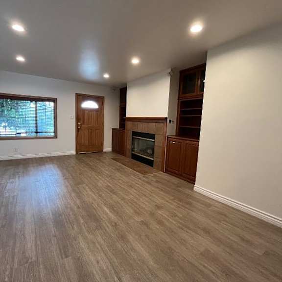 a room with wooden flooring and a window.