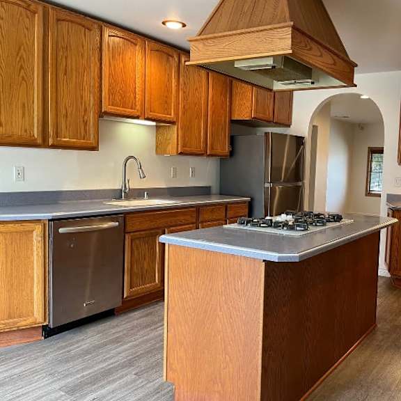 a kitchen with wooden cabinets and a central island.