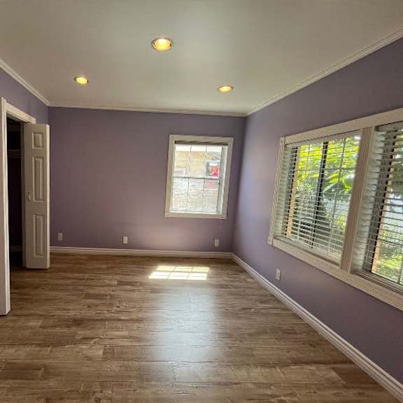 a room with purple walls and wooden flooring.