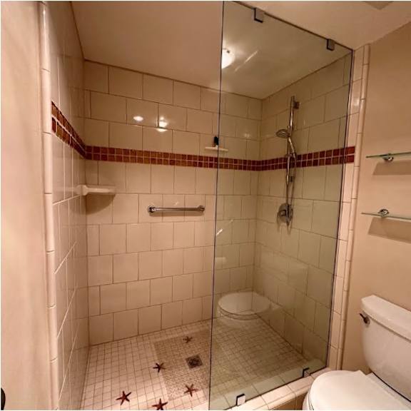 a bathroom with a toilet, a shower, and a bathtub.